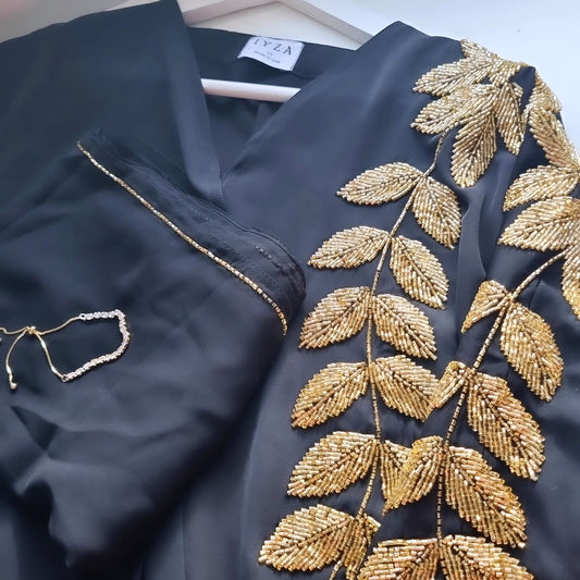 Black abaya with gold leaf embellishments