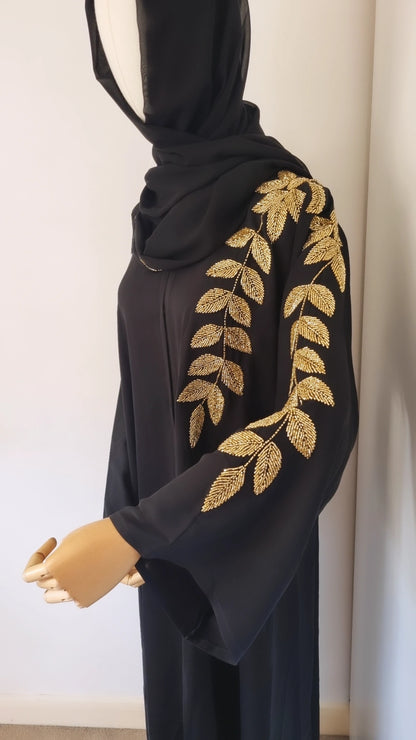 Black abaya with gold leaf embellishments